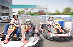 Happy family driving go kart on the track