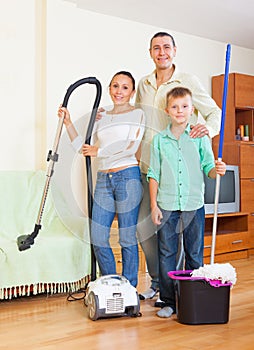 Happy family dusting in home