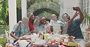 Happy family eating together at table