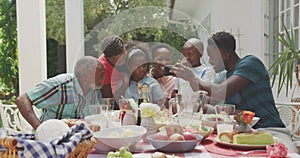 Happy family eating together at table