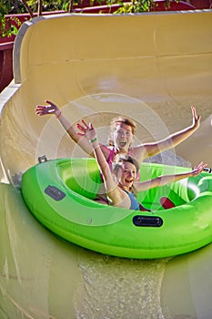 Happy family enjoy water slides in Aqua Park