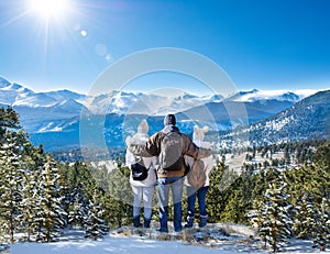 Happy family enjoying beautiful winter mountain view