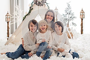 Happy family, enjoying christmas together in cozy home, decorated