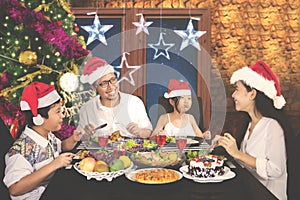 Happy family enjoying dinner at Christmas time