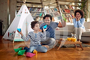 Happy family enjoying free time at home together. Family, together, love, playtime photo