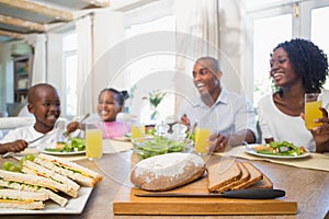 Happy family enjoying a healthy meal together photo