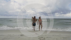 Happy family enjoying morning walk on the beach 4k