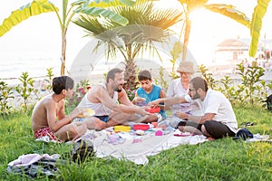 Happy family enjoying picnic on beach