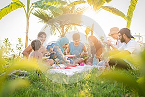 Happy family enjoying picnic on beach