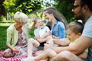 Happy family enjoying picnic in nature at summer