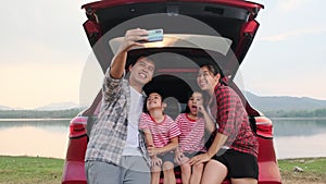 Happy family enjoying road trip on summer vacation. The family travels on the road in their favorite car. Holiday and travel famil