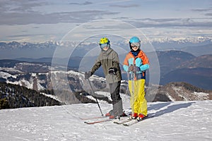 Happy family, enjoying ski holiday with children, sunny beautiful weather