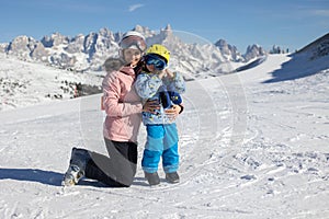 Happy family, enjoying ski holiday with children, sunny beautiful weather