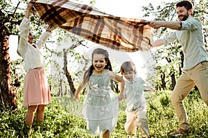 Happy family enjoying spring together at apple orchard