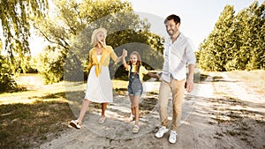 Happy Family Enjoying Walk Near River In Countryside, Panorama