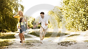 Happy family enjoying weekends and running on path photo
