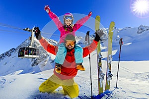 Happy family enjoying winter vacations in mountains . Ski, Sun
