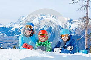 Happy family enjoying winter vacations in mountains . Ski, Sun, Snow and fun.