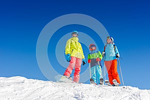 Happy family enjoying winter vacations in mountains . Ski, Sun, Snow and fun.