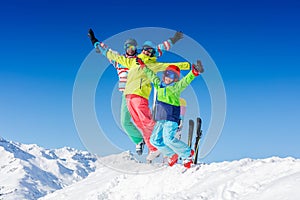 Happy family enjoying winter vacations in mountains . Ski, Sun, Snow and fun.