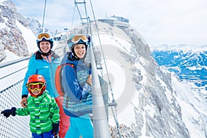 Happy family enjoying winter vacations in mountains . Ski, Sun, Snow and fun.