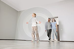 Happy family entering in their new apartment on moving day, low angle view