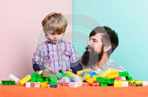Happy family. family leisure time. child development. building home with colorful constructor. father and son play game