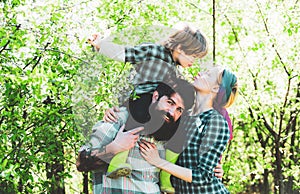 Happy family Farmers working with spud on spring field. Earth concept. Gardening in spring - happy family harvesting and