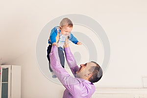 Happy family father and baby child son playing