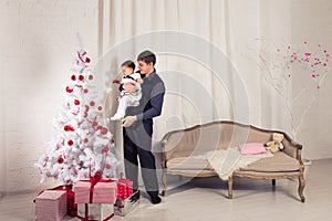 Happy family father and child baby daughter with Christmas tree