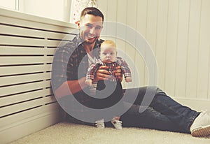 Happy family father and child baby son playing at home