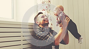 Happy family father and child baby son playing at home