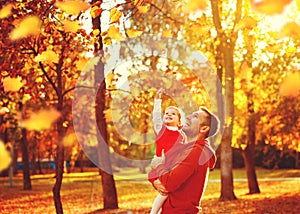 Happy family father and child daughter on a walk in autumn leaf
