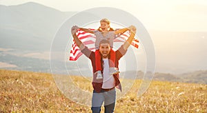 Happy family father and child with flag of united states enjoyi