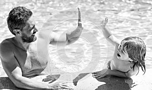 happy family of father and child having fun in summer swimming pool, summer