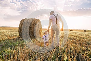 Happy family father and child son on nature at sunset