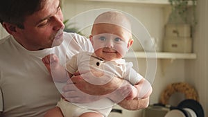 Happy family. Father holding little toddler child daughter. Dad baby girl relax playing having fun together at home