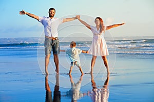 Happy family - father, mother, baby on summer beach vacation