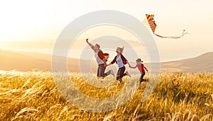 Happy family father, mother and child daughter launch a kite on