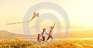 Happy family father of mother and child daughter launch a kite o