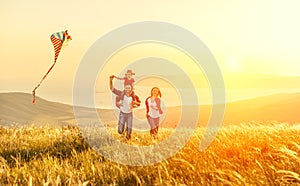 Happy family father of mother and child daughter launch a kite o