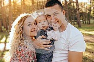 Happy family father, mother and child daughter outdoor  enjoying  sunset  - Image