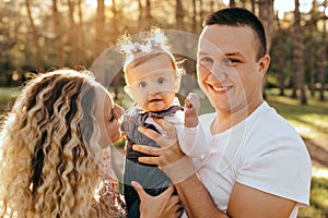 Happy family father, mother and child daughter outdoor  enjoying  sunset  - Image