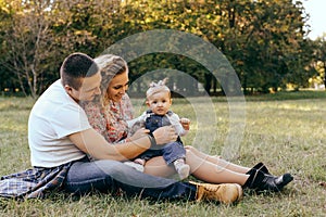 Happy family father, mother and child daughter outdoor  enjoying  sunset  - Image