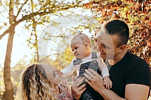 Happy family father, mother and child daughter outdoor  enjoying  sunset  - Image