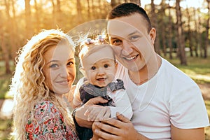 Happy family father, mother and child daughter outdoor  enjoying  sunset  - Image