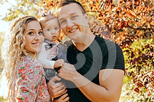 Happy family father, mother and child daughter outdoor  enjoying  sunset  - Image