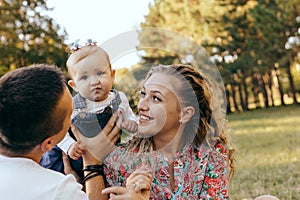 Happy family father, mother and child daughter outdoor  enjoying  sunset  - Image