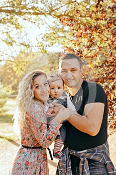 Happy family father, mother and child daughter outdoor  enjoying  sunset  - Image