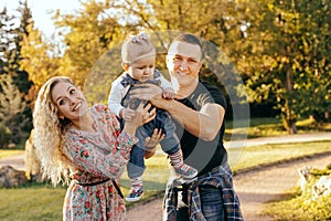 Happy family father, mother and child daughter outdoor  enjoying  sunset  - Image